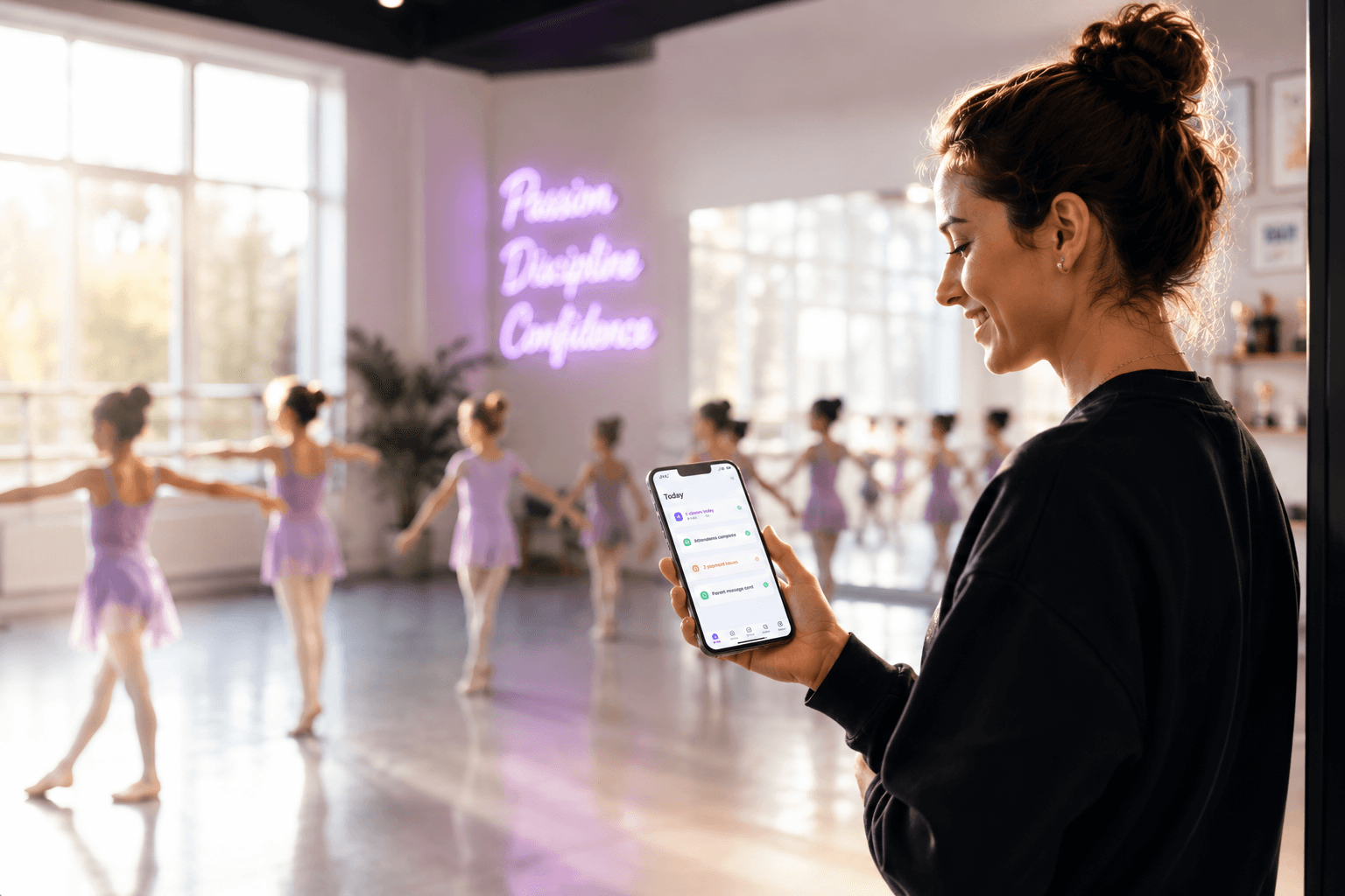 Studio owner checking Loop on her phone between ballet classes